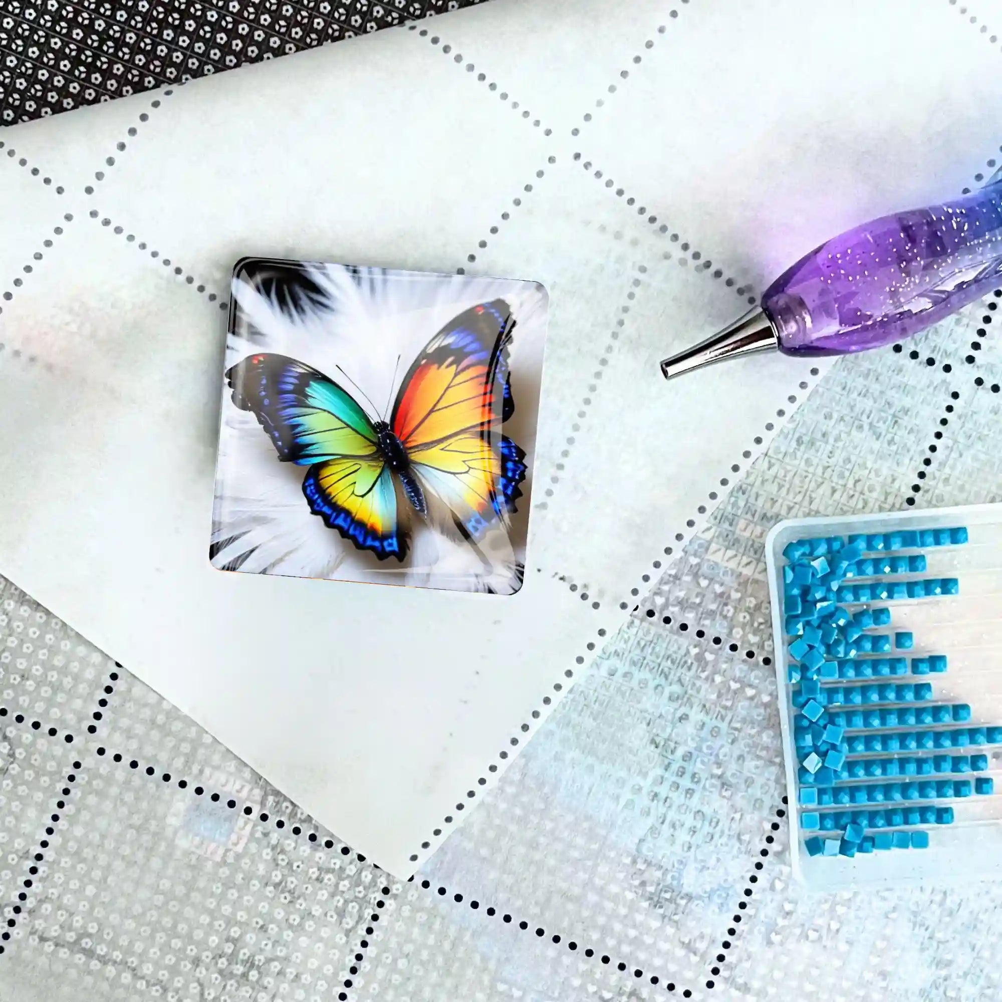 Schmetterling Cover Minder aus Glas als magnetisches Zubehör für dein Diamond Painting Set auf einer Leinwand.